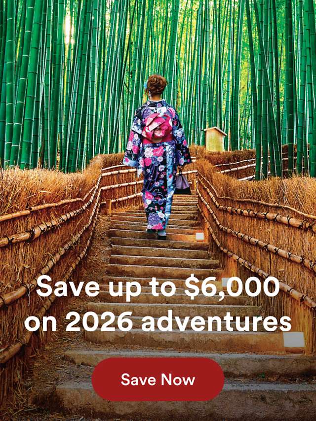 Lady walking through bamboo forest in Japan on an Overseas Adventure Travel with a promotion to save $6,000 on 2026 adventures.