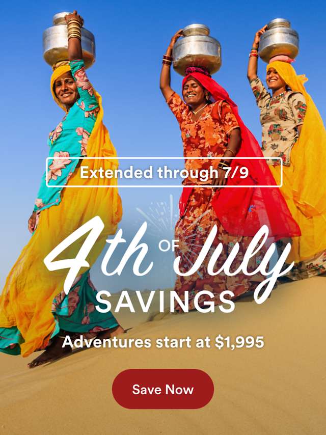 Promotional banner for 4th of July Savings. Adventures from $1,995. The background shows 3 ladies in colorful dresses on a sand dune in a desert.